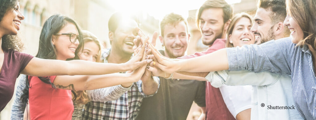 A group of people holding hands together